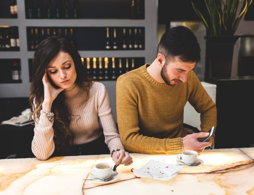 Young couple at the bar. Concept of betrayal.